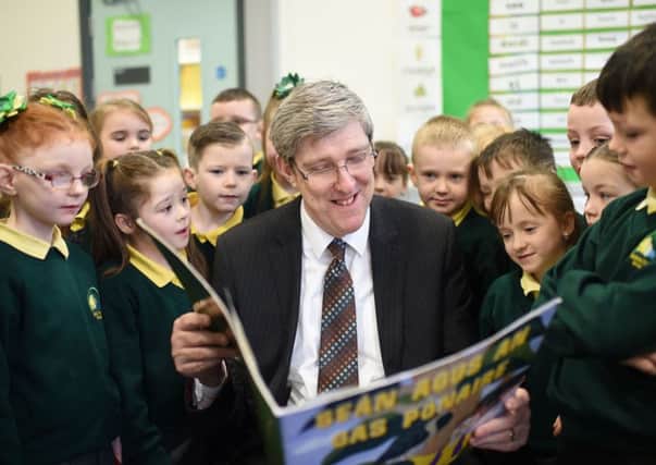 Former Education Minister John ODowd with pupils at Irish language school Bunscoil Bheann MhadagÃ¡in in north Belfast