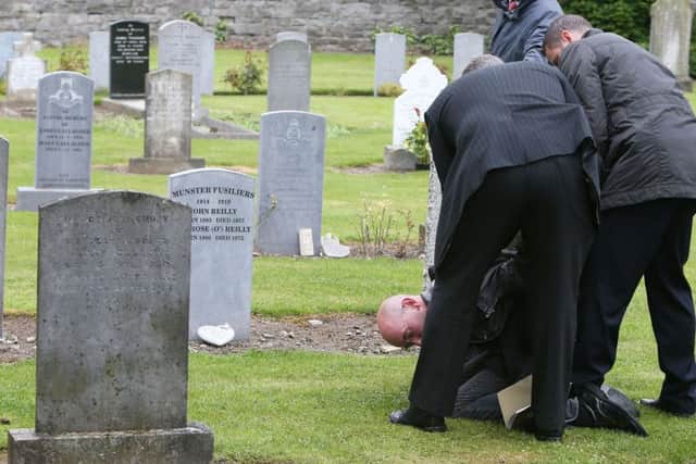 A lone protestor is arrested during a State ceremony to remember the British soldiers who died during the Easter Rising at Grangegorman Military Cemetery, Dublin. Photo:  Brian Lawless/PA Wire