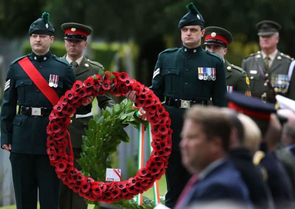 Members of the Royal Irish Regiment and members of the Irish defence forces hold wreaths during a State ceremony to remember the British soldiers who died during the Easter Rising at Grangegorman Military Cemetery, Dublin. Photo: Brian Lawless/PA Wire