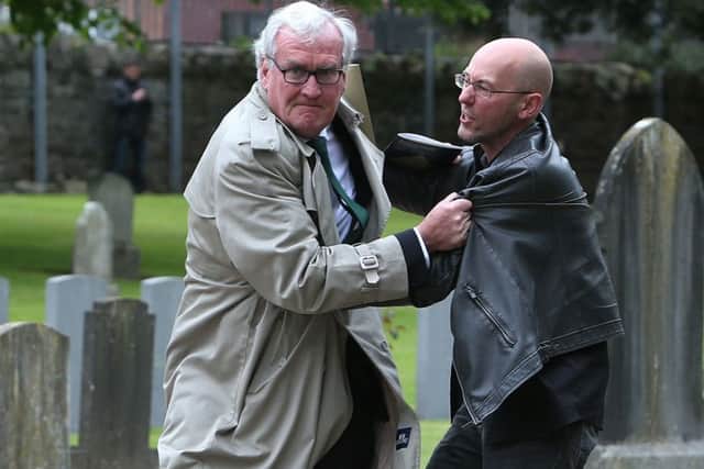 Canadian Ambassador to Ireland Kevin Vickers wrestles with a protester (right) during a State ceremony to remember the British soldiers who died during the Easter Rising at Grangegorman Military Cemetery, Dublin.   Photo: Brian Lawless/PA Wire