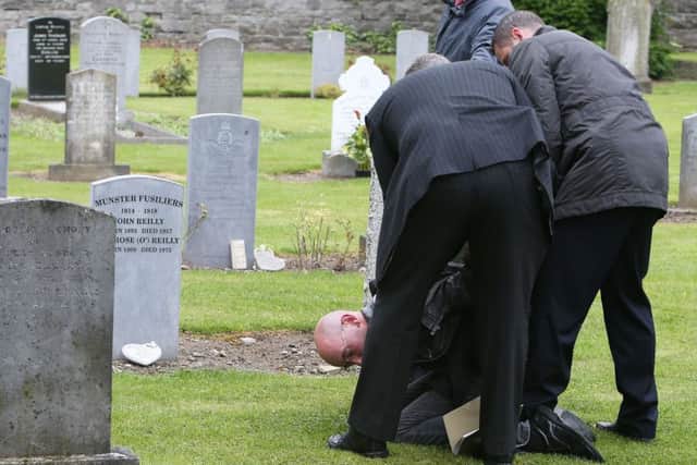 A lone protestor is arrested during a State ceremony to remember the British soldiers who died during the Easter Rising at Grangegorman Military Cemetery, Dublin.   Photo: Brian Lawless/PA Wire