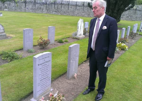 Kevin Myers looks at Margaret and John Naylor's grave at Grangegorman military cemetery after the event to mark the 1916 British dead of the Easter Rising. Pic by Ben Lowry