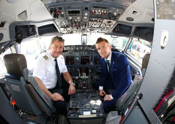 Northern Ireland's captain Steven Davis pictured with airline captain Vladimir Korosec as they leave from George Best Belfast City Airport