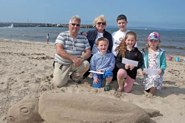 Sand Sculpture, Tony Hawkins, pictured with the winners in the competition on Saturday. They are, Katie Coyle (1st), Eryn Long (2nd) and Oliver Caldwell (3rd). Included is sponsor and judge, Brenda Caher from ShoreBird Coffee Hut and Ryan McLaughlin.