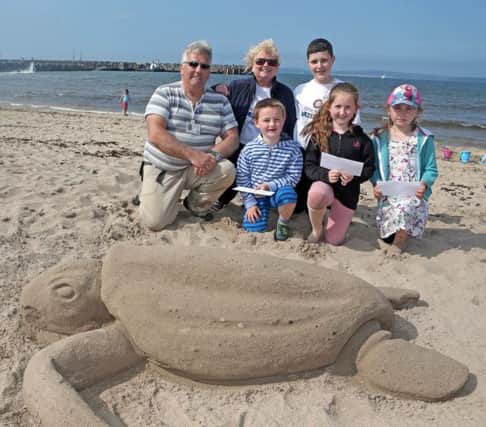 Sand Sculpture, Tony Hawkins, pictured with the winners in the competition on Saturday. They are, Katie Coyle (1st), Eryn Long (2nd) and Oliver Caldwell (3rd). Included is sponsor and judge, Brenda Caher from ShoreBird Coffee Hut and Ryan McLaughlin.