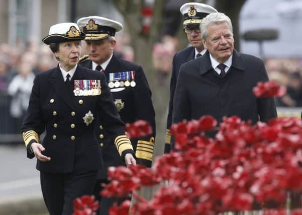 The Princess Royal and German President Joachim Gauck (right) pass the Weeping Window sculpture made of ceramic poppies as they attend a service at St Magnus Cathedral in Kirkwall, Orkney, to mark the centenary of the Battle of Jutland
