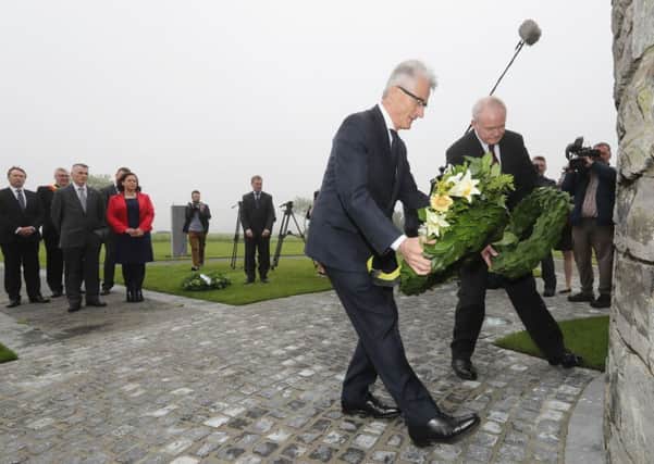 Martin McGuinness lays a wreath alongside Minister-President of Flanders Geert Bourgeois at the First World War monument in Flanders, Belgium