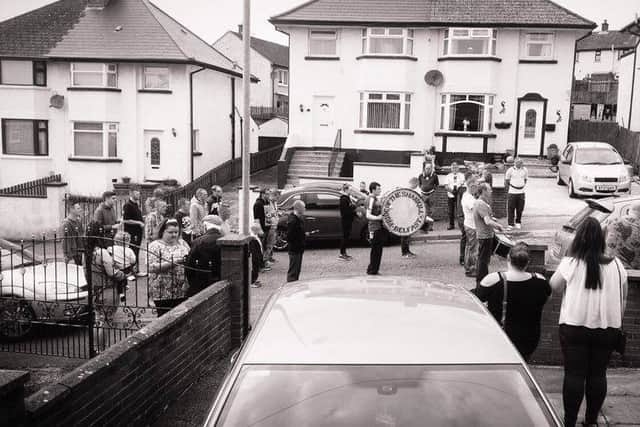 Members of Shankill Flute Band play outside the home of Vikki McKeown