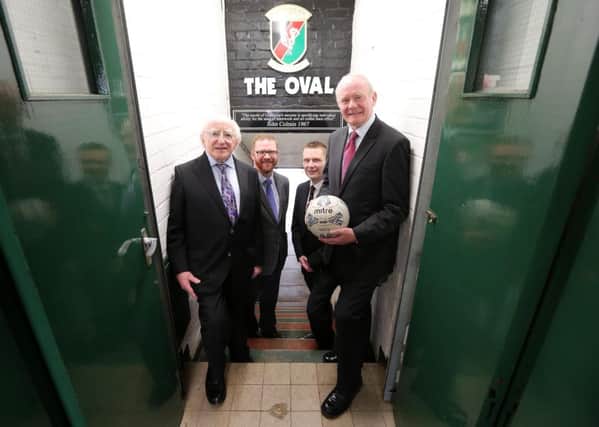 President of Ireland, Michael D. Higgins is pictured with deputy First Minister Martin McGuinness, Economy Minister Simon Hamilton and Glentoran Club Chairman Stephen Henderson during a visit to Glentoran Football Club grounds The Oval.