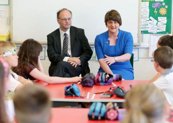 Peter Weir and Arlene Foster talking to pupils during their visit to Birches Primary School in Portadown