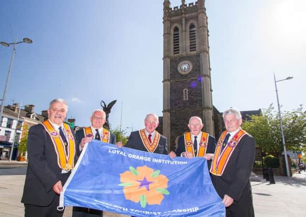 Grand Master of the Grand Orange Lodge of Ireland, Edward Stevenson (centre), presents senior Portadown Orangemen with a special flag to mark the tourist flagship status for this year's Co Armagh Twelfth of July parade. Pictured (L-R) are David Jones; Darryl Hewitt, District Master; Alan Burns and Cecil Allen