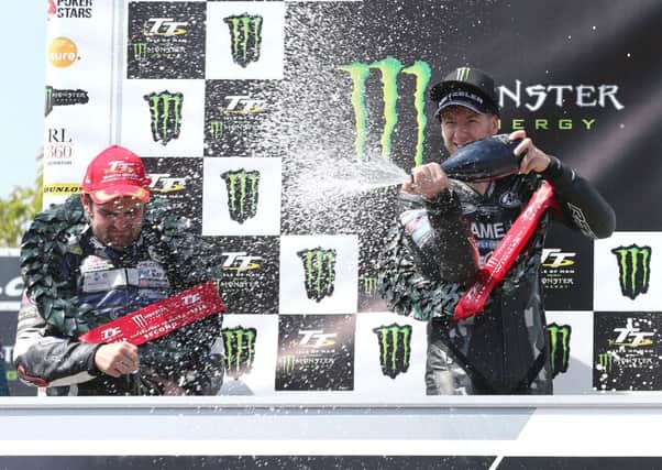 Ian Hutchinson (Team Traction Control Yamaha) celebrates winning the second Supersport race at the Isle of Man TT with runner-up, Michael Dunlop (MD Racing Yamaha).