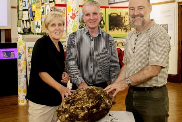Undated handout photo issued by the Cavan County Museum of (left to right) Savina Donohoe, Curator of Cavan County Museum, Turf Cutter Jack Conway, and Andy Halpin, Assistant Keeper, Irish Antiquities Division, National Museum of Ireland, with a prehistoric 10 kilo lump of bog butter thought to have been a gift to the gods which was found by turf cutters