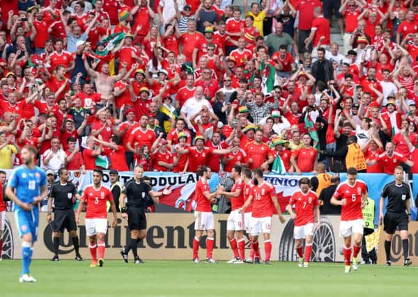 Wales players celebrate victory after the final whistle in front of the Welsh fans