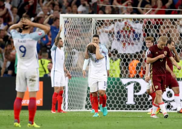 England's Jack Wilshere (centre) stands dejected with team mates after drawing with Russia