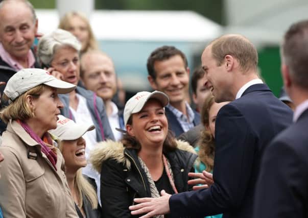 The Duke of Cambridge meeting revellers  as he makes their way down The Mall during the Patron's Lunch in central London in honour of the Queen's 90th birthday