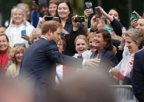 Prince Harry  meeting revellers  as he makes their way down The Mall during the Patron's Lunch in central London in honour of the Queen's 90th birthday