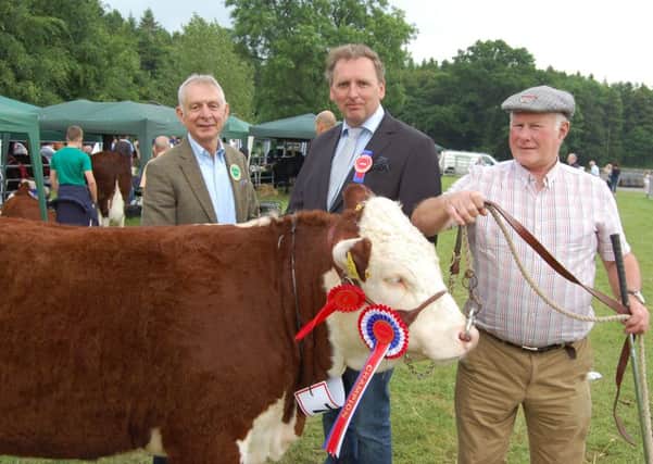 Judge Anders Mortensen (centre) from Denmark, congratulates Mervyn Richmond (right), from Co Fermanagh on winning the Hereford championship at Armagh Show 2016 with an excellent heifer. Adding his congratulations is Co Armagh Hereford breeder Robin Irvine