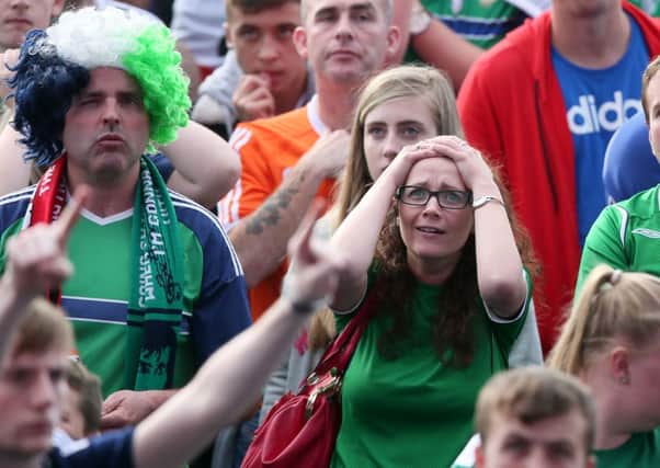 Northern Ireland fans look dejected whilst watching the UEFA Euro 2016 Group C match between Northern Ireland and Poland at the Titanic Quarter, Belfast