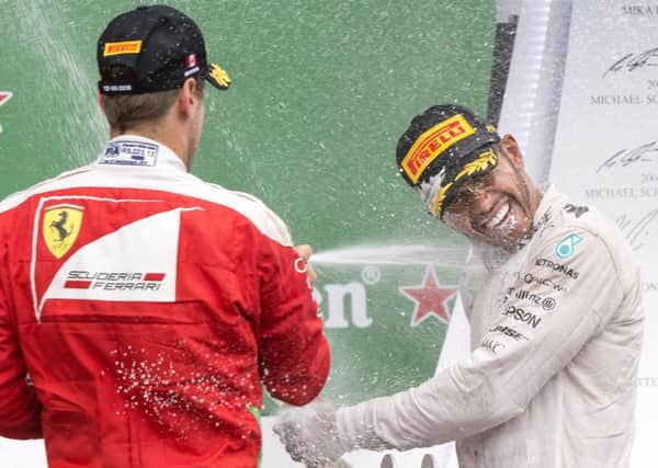 Lewis Hamilton (right) celebrates his win
