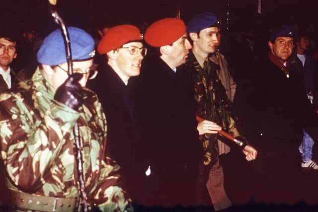 Peter Robinson pictured with Noel Little and others in the red berets of Ulster Resistance in late 1986. Picture: Pacemaker