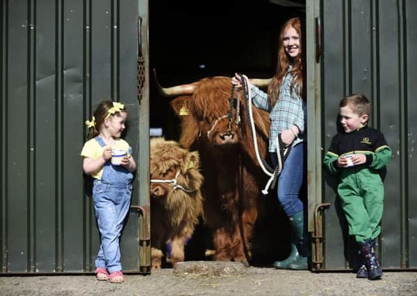 FREE USE PICTURE

Junior handler Laura Hunter, 16, and cousins Hannah Devine and Alan Marshall, both aged 4, share their ice-cream with Molly, the prize-winning Highland cow Molly, and her calf, at Barnhill Farm, Shotts, ahead of the 2016 Royal Highland Show. The Royal Highland Show, at Ingliston, Edinburgh, runs from 23-26 June 2016, and is Scotland's annual farming and countryside showcase.
Picture by JANE BARLOW

Â© Jane Barlow 2016 {all rights reserved}
janebarlowphotography@gmail.com
m: 07870 152324