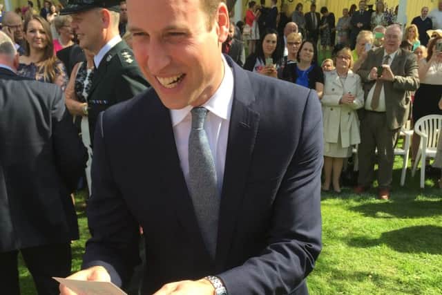 Prince William at Hillsborough Castle looks at card sent on his behalf to Georgina Shiels, who had congratulated him on his wedding.