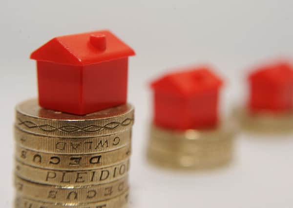 File photo dated 27/01/15 of plastic models of houses sitting on a pile of one pound coins, as buy-to-let lending for house purchase plunged by 85% month-on-month in April as a stamp duty hike took effect, banks and building societies have reported