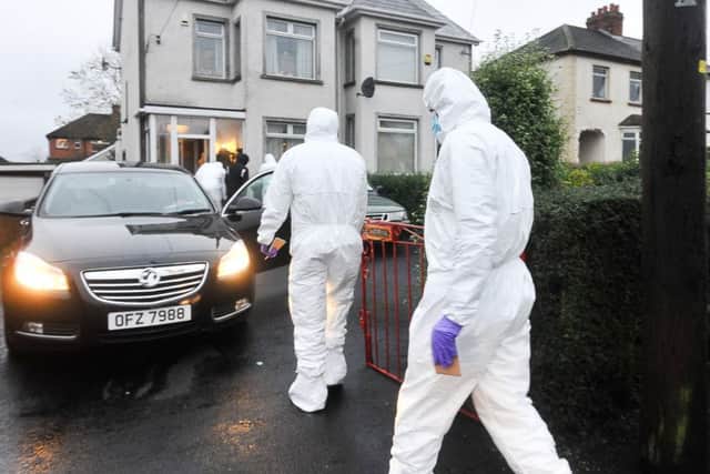 PSNI and forensic officers at the scene of Eddie Girvan's murder