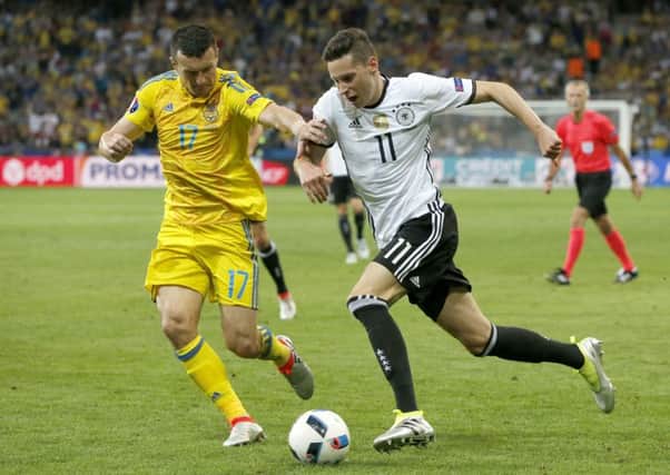 Ukraine's Artem Fedetskiy challenges Germany's Julian Draxler on Sunday