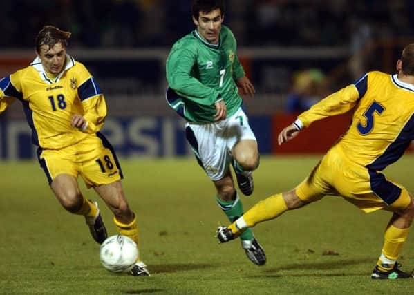 Keith Gillespie gets beteen two Ukraine defenders Radchenko and Kormylstev during a Euro 2004 qualifier in Belfast