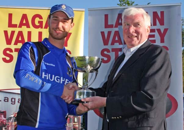 Then CIYMS captain Chris Dougherty receives the Lagan Valley Steels Twenty20 Cup from Tommy Anderson last summer