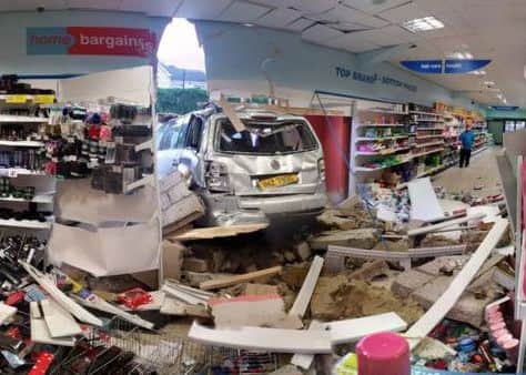 A man whose wife and son narrowly missed being injured when a car smashed through the wall of shop in County Tyrone has said it sounded "like a bomb".
No-one was in the car when it rolled down a hill and careered rear-end first into the side of Home Bargains.
It happened at about 17:00 BST on Thursday in Dromore Road Retail Park in Omagh.
Simon Burke was parked outside the shop at the time of the incident.