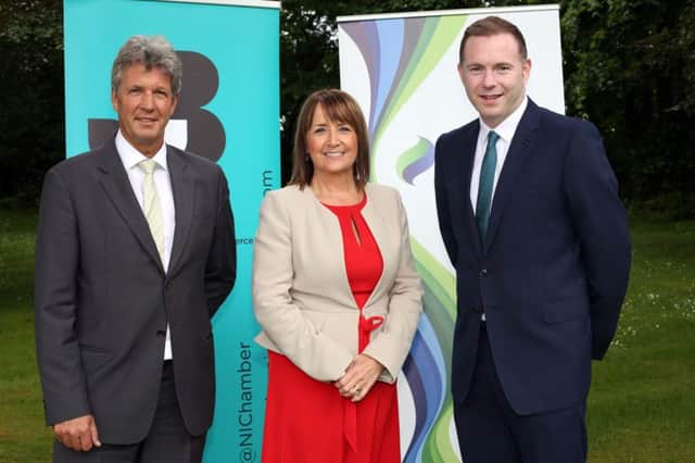 Infrastructure Minister Chris Hazzard , right, with SSE Ireland chairman Mark Ennis and NI Chamber cheif executive Ann McGregor
