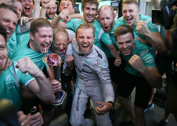 Mercedes driver Nico Rosberg of Germany,  celebrates with Mercedes mechanics