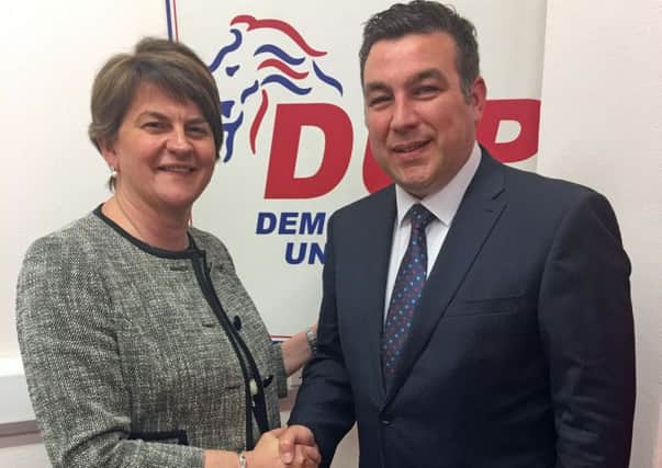 Alastair Patterson being welcomed to the DUP by Arlene Foster