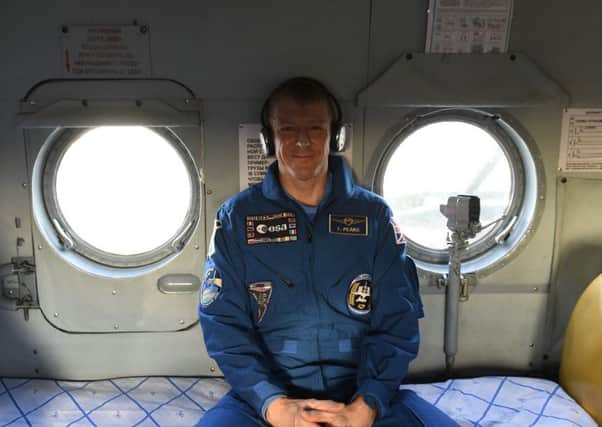 Handout file photo issued by the European Space Agency dated 18/06/16 of Major Tim Peake in a recovery helicopter shortly after landing in Kazakhstan, as the British astronaut said he feels like he is having the "world's worst hangover"