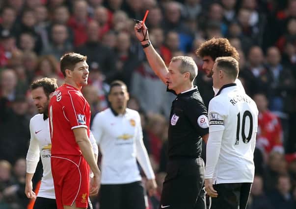 Referee Martin Atkinson - seen here sending off Liverpool's Steven Gerrard - will referee Saturday's Euros clash in Paris