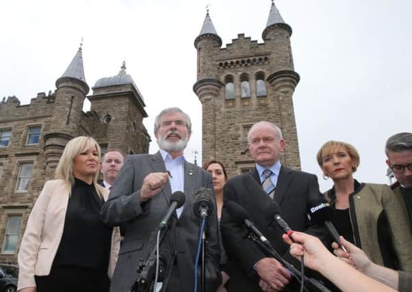 Sinn Fein president Gerry Adams, joined by Deputy First Minister Martin McGuinness and other Executive ministers, speaks to the media outside Stormont yesterday