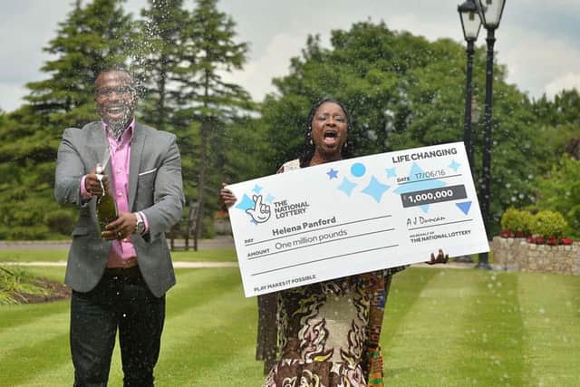 Helena Panford (59), originally from Ghana, pictured with her brother, Patrick, won a staggering one million pounds after her bus broke down on the way to work