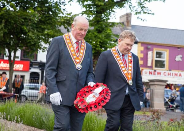 Grand Master Edward Stevenson and Deputy Grand Master Harold Henning pay their respects at the war memorial in Ards earlier this month. 	Photograph: Graham Curry