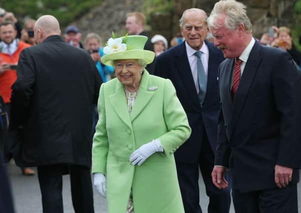 Queen Elizabeth II and the her husband, the Duke of Edinburgh, meeting Northern Ireland national Trust chairman Bob Brown during a visit to the Giant's Causeway on the Co Antrim coast during the second day of her visit to Northern Ireland to mark her 90th birthday
