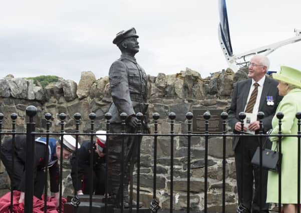 Queen Elizabeth II unveils a statue of Robert Quigg, VC during a visit to Bushmills Village on the second day of her visit to Northern Ireland to mark her 90th birthday