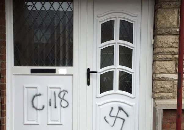 Undated handout photo issued by PSNI Armagh of racist graffiti including a swastika symbol daubed on the door of a house in the Orangefield area of Co Armagh