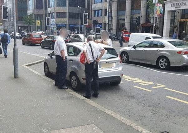 This picture of the traffic attendants and the car was taken by a News Letter reader in Belfast city centre last Thursday