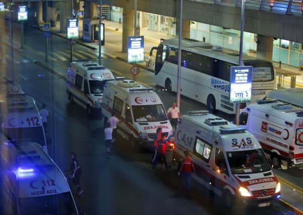Turkish rescue services gather outside Istanbul's Ataturk airport after two explosions on Tuesday, June 28, 2016.