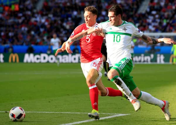 Wales' James Chester (left) and Northern Ireland's Kyle Lafferty battle for the ball