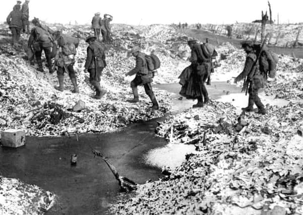 File photo dated 25/09/1916 of British soldiers negotiating a shell-cratered winter landscape along the River Somme in late 1916