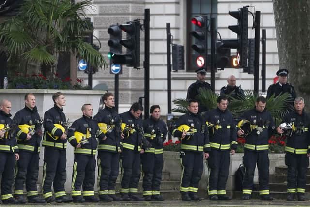 Members of the London Fire Brigade pay their respects