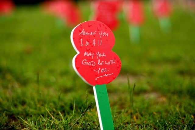 A message on a memorial poppy placed in the ground ahead of the Commemoration of the Centenary of the Battle of the Somme